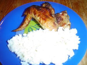 Pečená kuřecí křídla na medu a česneku podaná s vařenou rýží